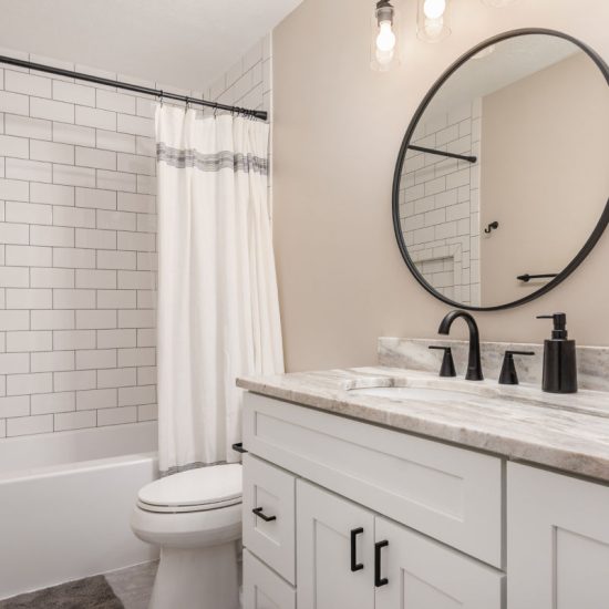 Bathroom renovation with new vanity mirror and subway tile shower with tub